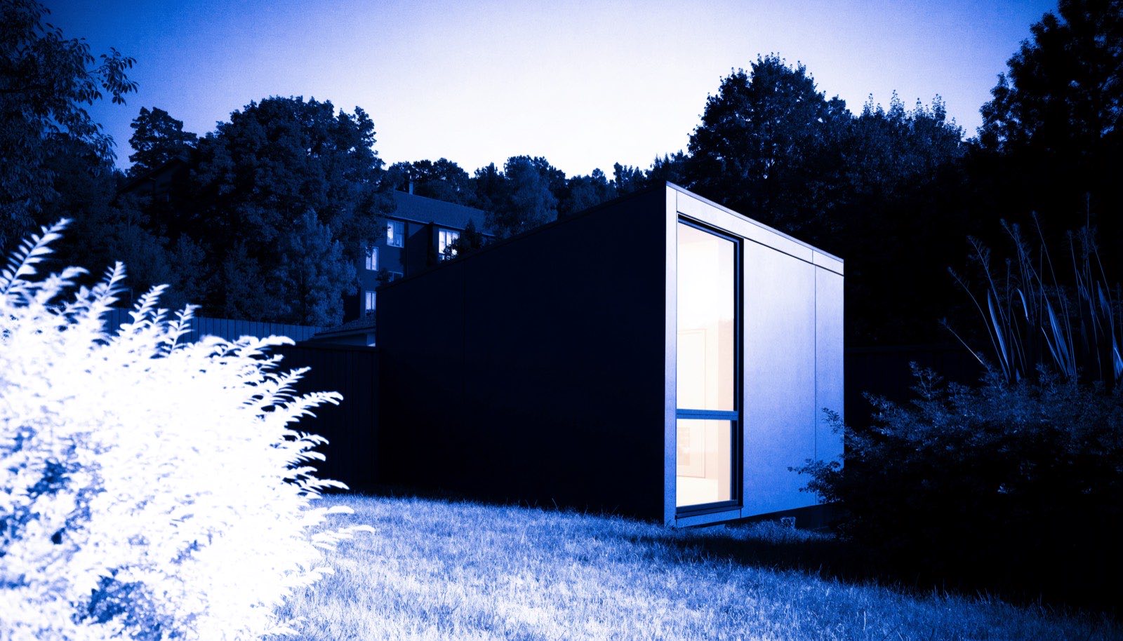 A small modern backyard dwelling unit at dusk, rendered in dark blueprint tones